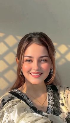 Smiling woman with long hair and traditional clothing in soft lighting