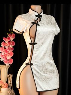 White cheongsam dress with black trim and high slits on a mannequin