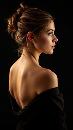 Woman with an updo and bare shoulders against a dark background
