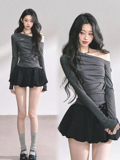 Woman with long black hair wearing an off-shoulder top and black skirt indoors