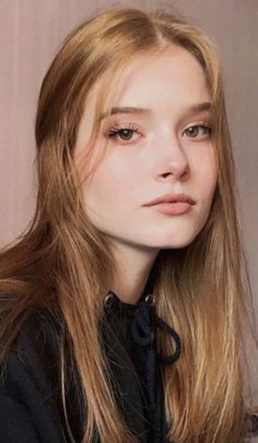 Young woman with long blonde hair wearing a black hoodie