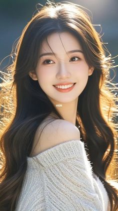 Woman with long hair and an off-shoulder sweater in soft backlight