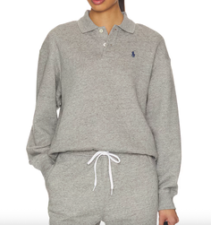 Person wearing a gray long-sleeve polo sweatshirt and matching drawstring pants