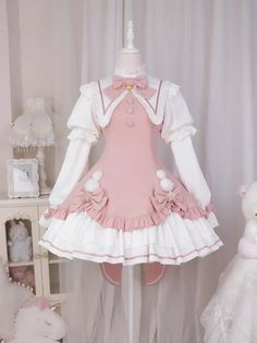 Pink and white lolita dress with ruffles and bows on a mannequin