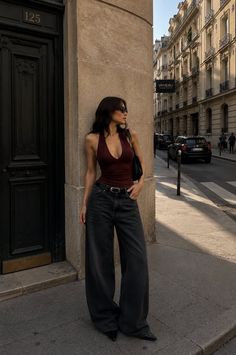 Woman in a halter top and wide leg jeans on a city street