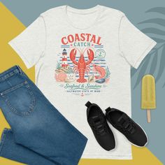 White t-shirt with a seafood graphic, jeans, sneakers, and a popsicle on a two-tone background