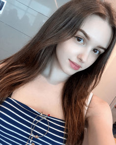 Woman with long brown hair wearing a striped top and glasses
