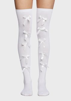 Pair of white thigh-high socks with white bows on a plain background