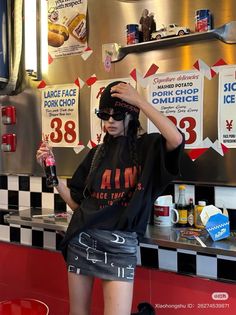 Woman in a black beanie and mini skirt holding a Coca-Cola bottle in a diner