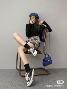 Woman in a beret and mini skirt sitting on a chair, taking a selfie