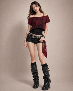 Woman in a crop top, short shorts, and leather boots posing in a studio