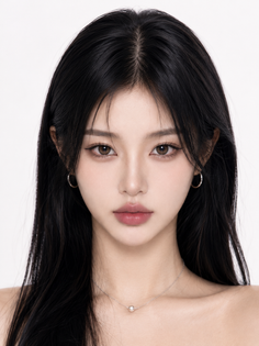Woman with long black hair and a necklace, looking directly at the viewer