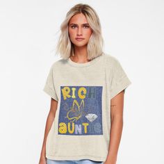 Woman with short blonde hair wearing a t-shirt with a 'Rich Auntie' graphic