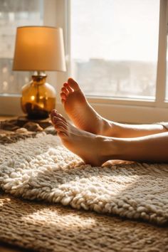 Bare feet resting on a fluffy rug in warm window light