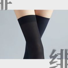 Person wearing black thigh-high stockings with crossed legs in a studio