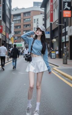 Woman in a crop top and mini skirt with a camera on a city street
