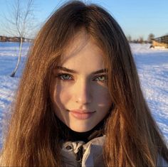 Woman with long hair and green eyes in a winter outdoor setting