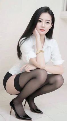 Woman in a white shirt and black stockings squatting with a provocative pose