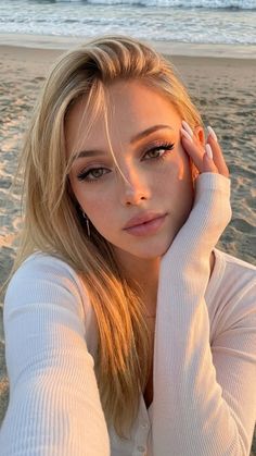 Blonde woman with long hair on a beach at golden hour