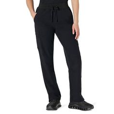 Person wearing black drawstring pants with cargo pockets and black shoes