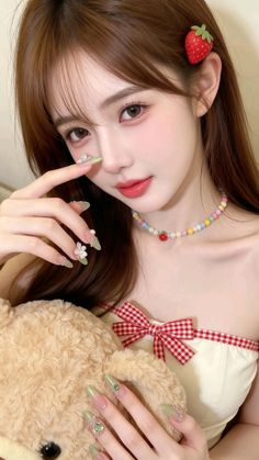 Woman with long hair and a strawberry hair clip holding a teddy bear