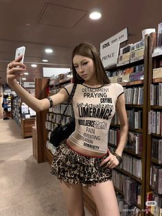 Woman in a tight top and leopard print skirt taking a selfie in a store