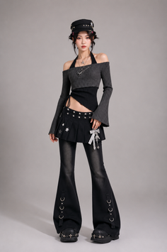 Woman in a dark aesthetic outfit with an off-shoulder top and bell-bottom pants