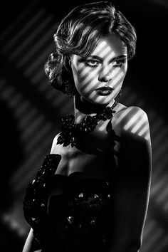 Woman in a strapless dress with dramatic lighting and shadow stripes