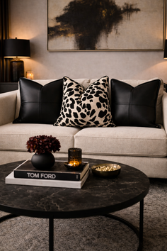 A modern living room with a sofa, coffee table, and decorative accents