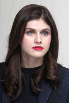 Woman with long dark hair and blue eyes wearing red lipstick