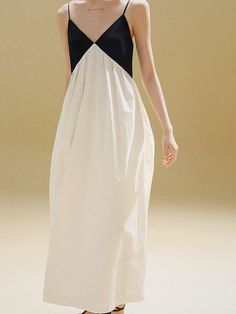 Woman in a black and white maxi dress with spaghetti straps