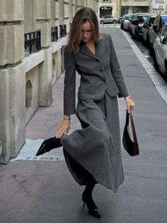 Woman in a gray suit and heels on a city street