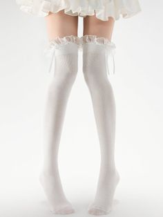 Person wearing white thigh high socks with ruffle trim and a white dress
