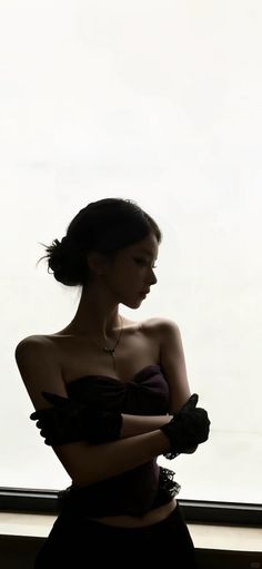 Woman in a strapless dress and black gloves with an updo hairstyle