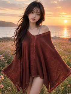 Woman in an off-shoulder top standing in a field at sunset