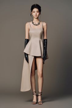 Woman in a beige dress with long gloves and high heels in a studio
