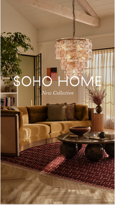 A modern living room with a sectional sofa, coffee table, and chandelier