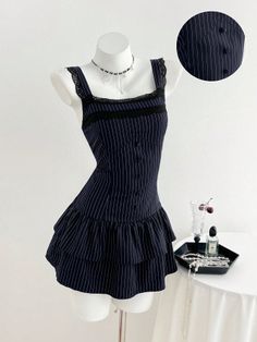 Pinstripe dress with black lace trim on a mannequin with a choker necklace