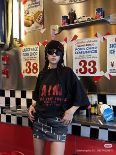 Person in a black beanie and sunglasses with braided hair in a diner setting