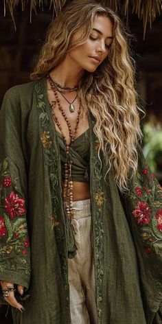 Woman with long wavy hair wearing an embroidered jacket and beaded necklaces