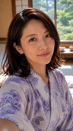 Woman in a purple floral print kimono indoors with soft lighting
