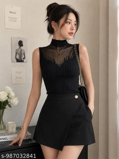 Woman in a black sleeveless top and skirt with an updo hairstyle indoors