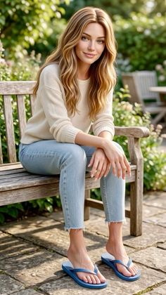 Woman with long blonde hair sitting on a wooden bench outdoors