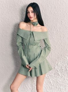 Woman in a green striped off-shoulder dress with a matching choker