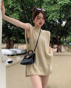Woman in a knitted top winking with her tongue out outdoors