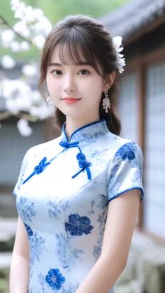 Woman in a blue floral cheongsam with white flowers in her hair