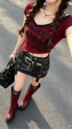 Person in a red crop top, studded mini skirt, and red boots outdoors