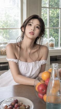 Woman in a white off-shoulder dress in a bright kitchen