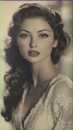 Woman with curly hair wearing a lace dress, looking directly at the viewer