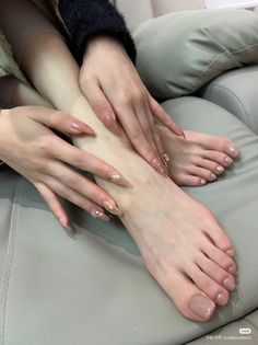 Hands and feet with matching nude and glitter nail polish